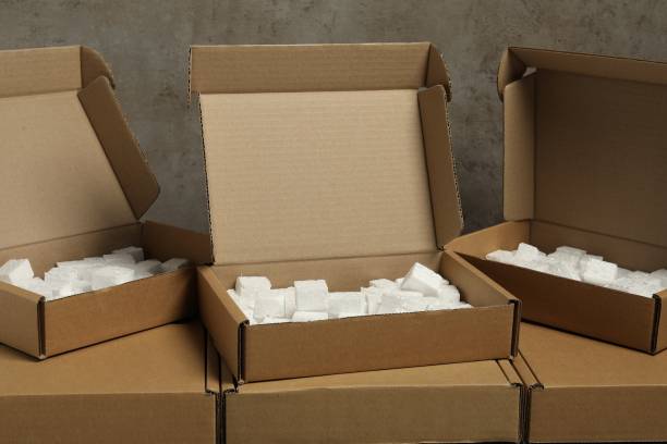 istock Many closed and open cardboard boxes with pieces of polystyrene foam on grey textured background 1893245869