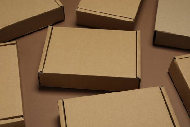 istock Many closed cardboard boxes on brown background, closeup 1893246533
