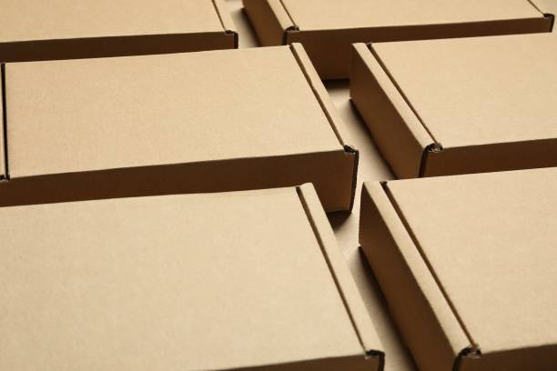 istock Many closed cardboard boxes on light brown background, closeup 1893247050