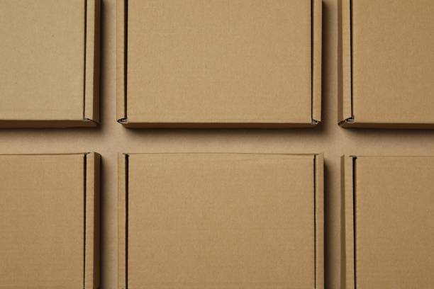 istock Many closed cardboard boxes on light brown background, flat lay 1893247561
