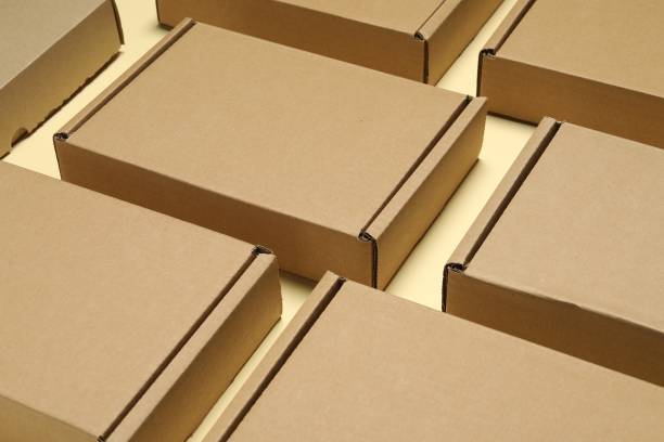 istock Many closed cardboard boxes on pale yellow background, closeup 1893247576