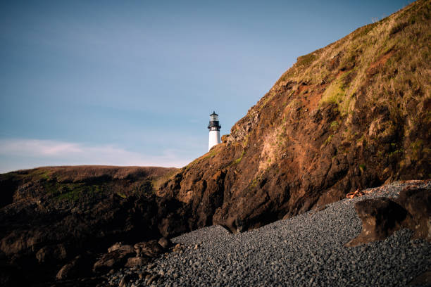 The Yaquina Head Lighthouse overlooking the Pacific Ocean at the Oregon coast, USA.  Shot on a cold but sunny December day.  Unique minimalist composition.