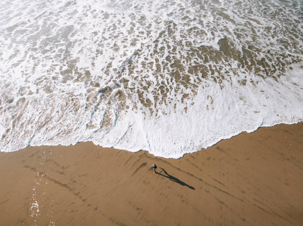 istock Boy Running From The Ocean Surf on the Oregon Coast 1893258376
