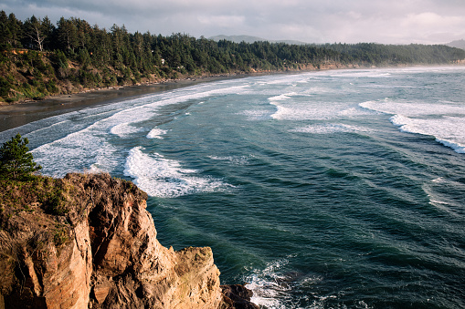 Aerial drone footage from the coast of the Pacific Northwest, featuring Oregons beautiful rugged terrain and blue ocean waves.  Captured at Otter Rock near Lincoln City, Oregon, USA.