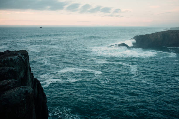 Aerial drone footage from the coast of the Pacific Northwest, featuring Oregons beautiful rugged terrain and blue ocean waves.  Captured in Depoe Bay, Oregon state,  USA.