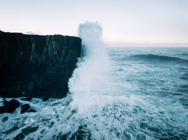 Crashing Waves on Rock Formations At Oregon Coast Aerial drone footage from the coast of the Pacific Northwest, featuring Oregons beautiful rugged terrain and blue ocean waves. Captured in Depoe Bay, Oregon state, USA. breaking wave stock pictures, royalty-free photos & images