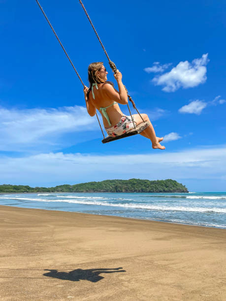 istock LOW ANGLE VIEW: Smiling young lady enjoying on a beach swing at Playa Venao 1893310686