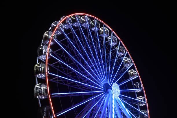 istock Beautiful glowing Ferris wheel against dark sky 1893354781