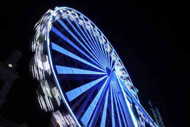 istock Beautiful glowing Ferris wheel against dark sky, low angle view 1893355303
