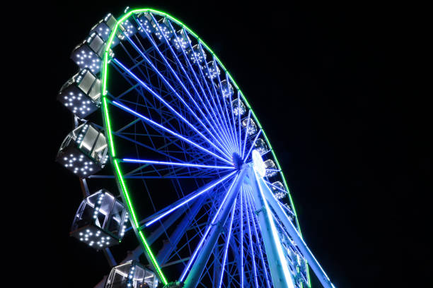 istock Beautiful glowing Ferris wheel against dark sky, low angle view 1893355827