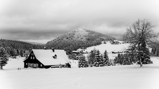 Jizerka Village and Bukovec Mounain in winter. Jizera Mountains, Czech Republic. Black and white image.