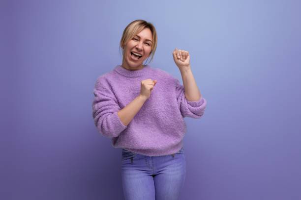 istock adorable energetic pleasant blond young woman with a grimace on a bright plain background 1893392350