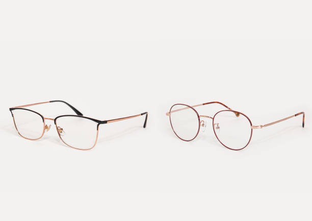 istock Two stylish gold eyeglasses isolated on white background perspective view 1893398127