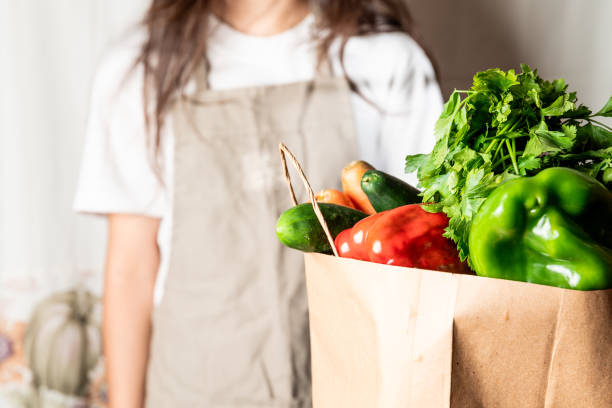 istock buying fresh vegetables with different currencies 1893480752