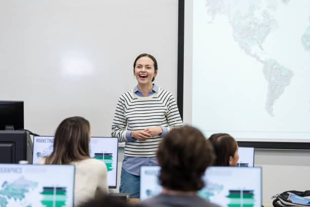 istock Young adult female professor teaches college-level computer class 1893496020