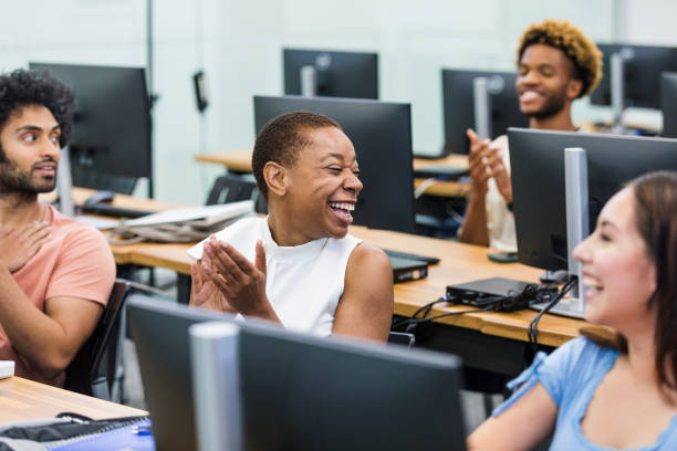 istock Clapping after lecture, female student turns to laugh with friend 1893496043