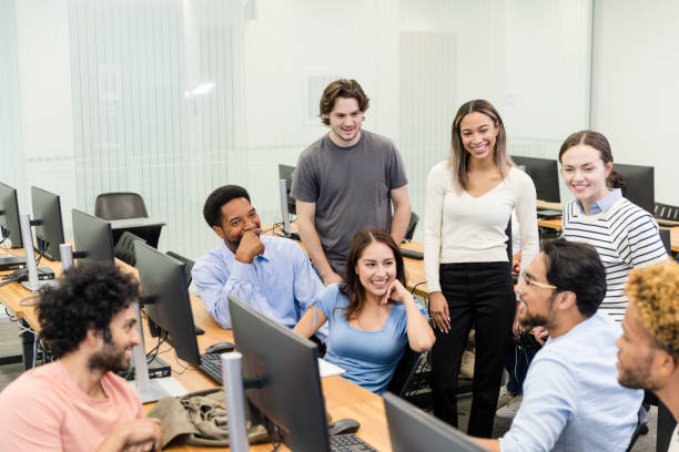istock Multiracial group of college students chat in computer lab 1893496595