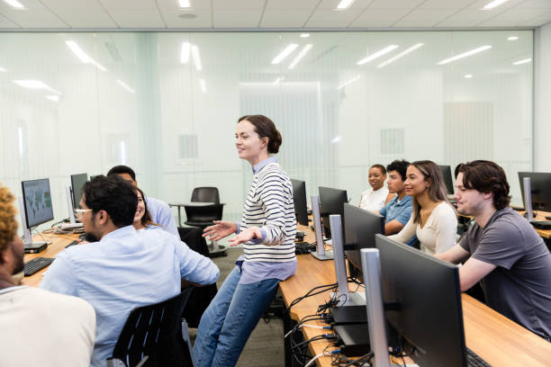 istock Young adult female professor interacts with diverse college students 1893496607