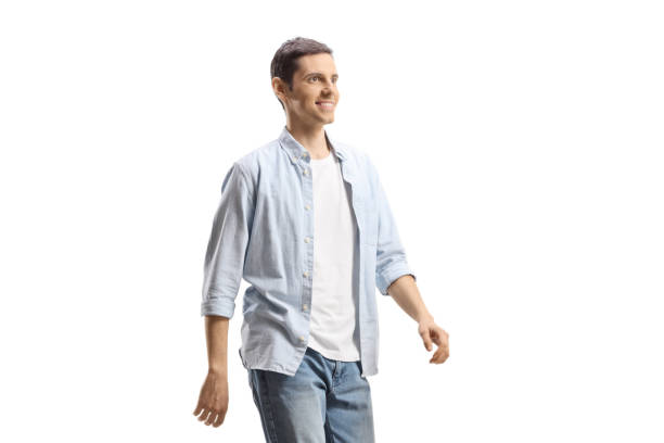 istock Young man in jeans and shirt walking 1893496646