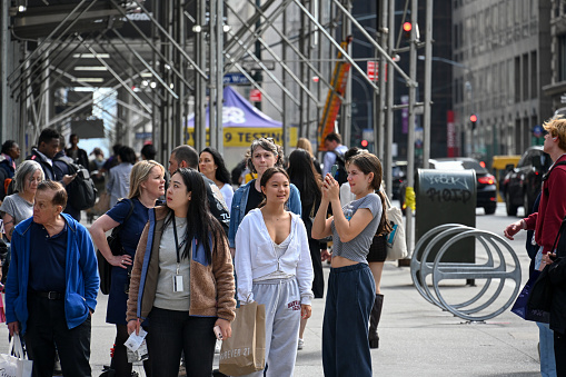New York, USA, April 6, 2023 - Tourists and locals cross the intersection of 42nd Street and 5th Ave, Midtown Manhattan, New York.