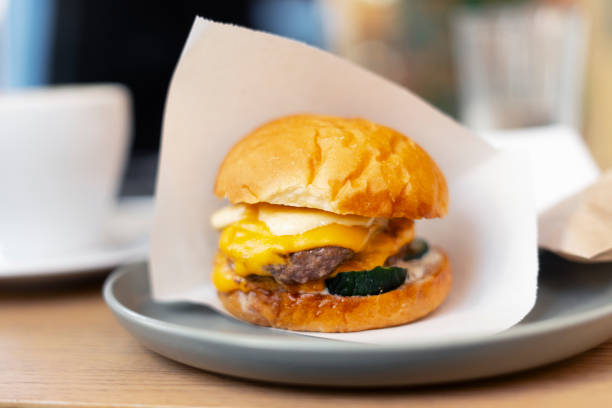 istock American burger with meat and cheese on plate in cafe 1893515556