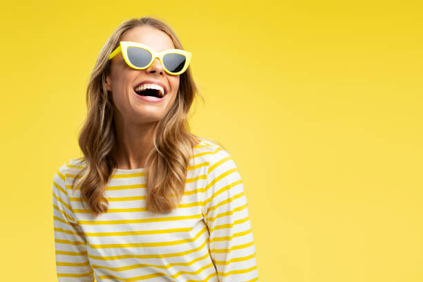 노란색 배경에 고립 된 선글라스를 착용 한 세련된 머리를 가진 초상화 행복 한 아름 다운 여자, - sunglasses women studio shot isolated 뉴스 사진 이미지