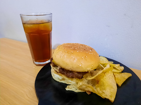Tasty Encore Burger With Potato Chip And Tea Cool. Food And Drink Menu