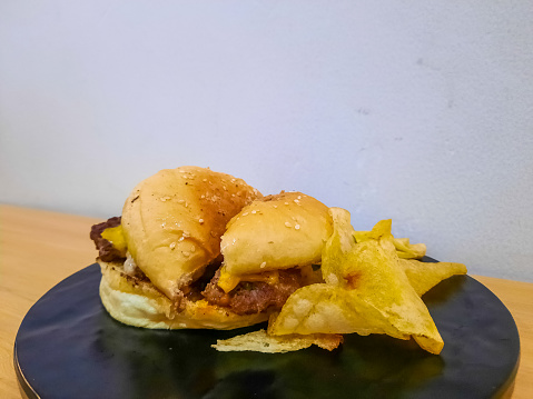 Slice Of Encore Burger With Burger Bun, Beef Patty, American Red Cheddar Cheese. Food Menu.