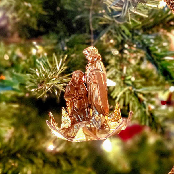 Christmas nativity scene with baby Jesus, Mother Mary and Joseph with Warm Golden Lights