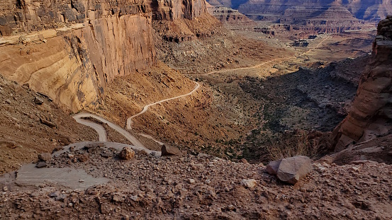 The descent of Shafer Switchbacks; the red rock ledges and cliffs encroaching, with each hairpin turn revealing new stomach-dropping slopes angling dangerously below