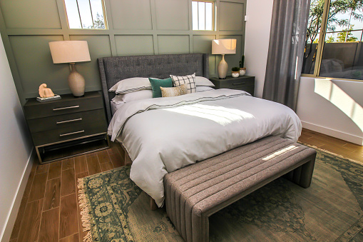 Master Bedroom With Bed, Nightstands And Foot Stool