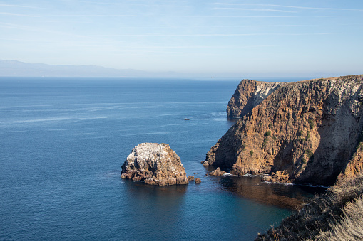 View from the cliffs along Santa Cruz Island within Channel Islands National Park looking across the pacific ocean towards Ventura Coastline, California.