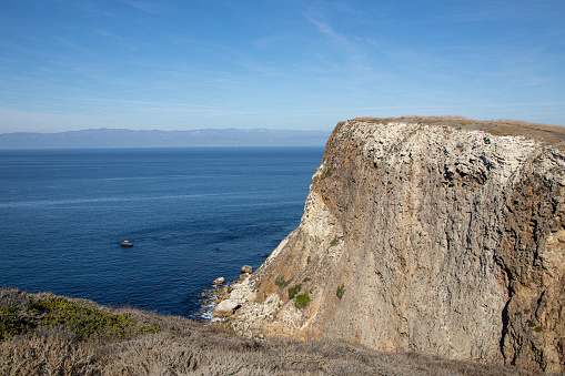 View from the cliffs along Santa Cruz Island within Channel Islands National Park looking across the pacific ocean towards Ventura Coastline, California.