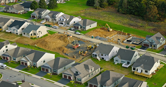 Aerial shot of new houses under construction in Emmaus, a borough in Lehigh County, Pennsylvania, on an overcast day in Fall.