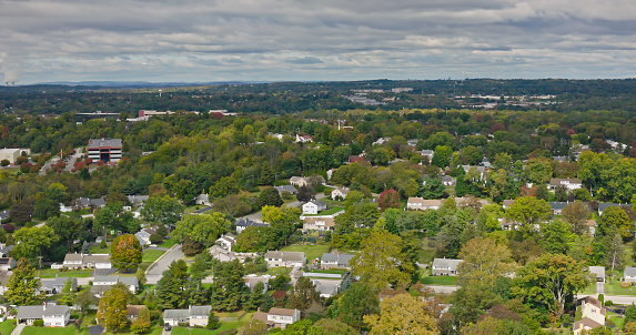 Aerial shot of leafy residential streets on an overcast day in Fall in King of Prussia, Pennsylvania.