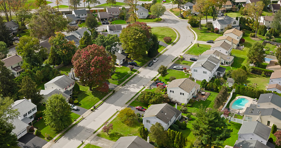 High angle aerial shot of leafy residential streets on an overcast day in Fall in King of Prussia, Pennsylvania.