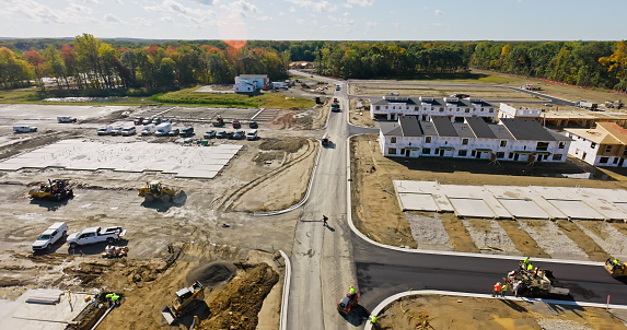 Aerial shot of suburban tract housing under construction in Ann Arbor, Michigan on a sunny day in Fall. \nAuthorization was obtained from the FAA for this operation in restricted airspace.