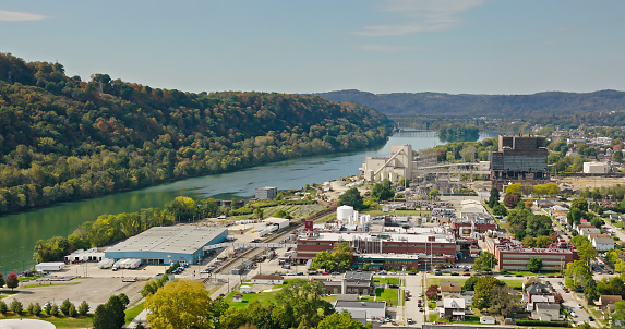 Aerial shot of power plant and industrial buildings on the bank of the Allegheny River in Springdale, a town 18 miles north of Pittsburgh in Allegheny County, Pennsylvania on a Fall day.