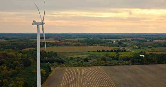 Aerial shot of wind turbine in an agricultural farm near Scottville, a city in Mason County in the U.S. state of Michigan, on an overcast day in Fall.