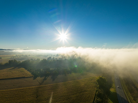 Aerial shot of agricultural fields in Hughesville, a borough in Lycoming County, Pennsylvania on a misty morning in Fall.