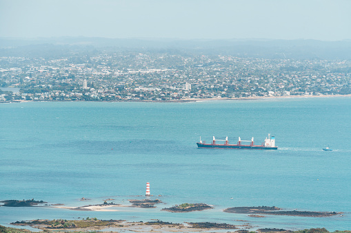 Rangitoto Island is a young volcanic island on the outskirts of Auckland and a popular day hiking destination from Auckland. The image depicts the view from Rangitoto Island towards Auckland.