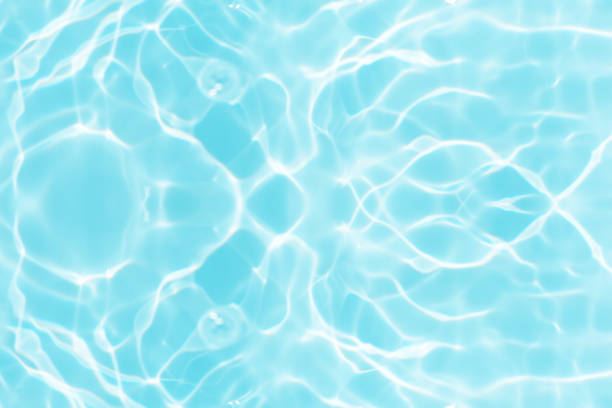 istock Bluewater waves on the surface ripples blurred. Defocus blurred transparent blue colored clear calm water surface texture with splash and bubbles. Water waves with shining pattern texture background. 1893772886