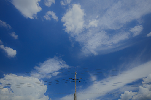 transmission tower with power lines and a blue sky