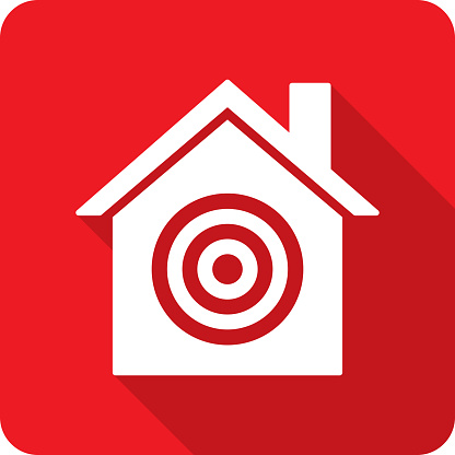 Vector illustration of a house with target icon against a red background in flat style.