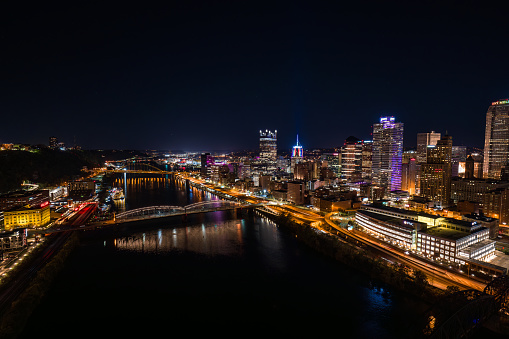 Aerial view of downtown Pittsburgh, Pennsylvania next to Monongahela River on a Fall night.