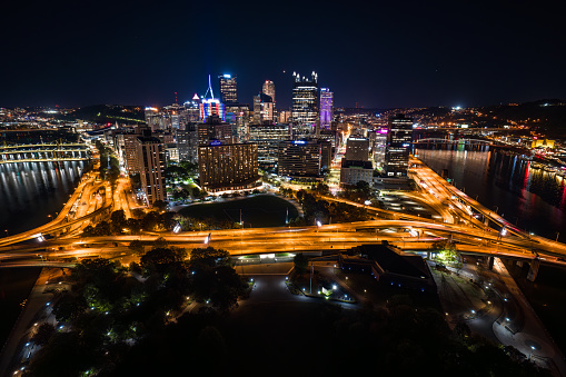 Aerial view of downtown Pittsburgh, Pennsylvania on a Fall night, with Allegheny River and Monongahela River on both sides of the frame.