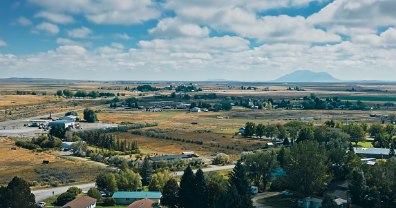 Aerial view of rural landscape around the town of Arco in Butte County, Idaho, on a mostly clear day in Fall.