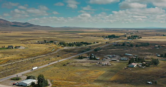 Aerial view of rural landscape around the town of Arco in Butte County, Idaho, on a mostly clear day in Fall.