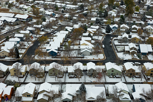 Aerial shot of houses in Old Prospect, Fort Collins, Colorado on a snowy, overcast day in Fall.