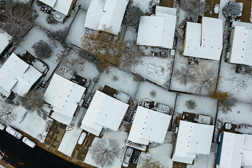 Aerial shot of houses in Old Prospect, Fort Collins, Colorado on a snowy, overcast day in Fall.